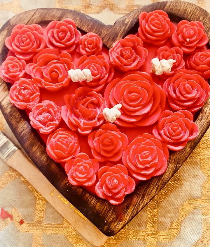 Wooden heart tray filled with red rose candles